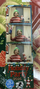 A woman in a festive sweater and green elf hat poses in three photo booth pictures at a Holiday Party, holding wrapped gifts and smiling. A Holiday Party 2025 sign, WorkIT News mention, and coworking center logo appear at the bottom. -WorkIT Coworking Center